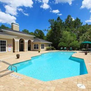 A beautiful backyard pool under a clear blue sky, perfect for relaxation.