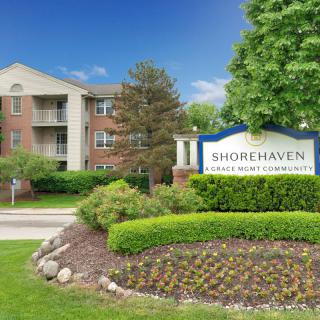 A view of the Shorehaven apartment complex with landscaped gardens and a prominent entrance sign.