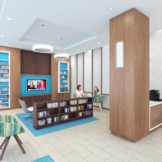 A modern lobby area with comfortable seating and a television.