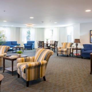 A spacious living room with comfortable seating and ambient lighting.