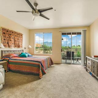 A beautifully decorated bedroom with a scenic view and modern furnishings.