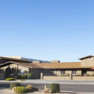 A desert commercial building with a clear blue sky in the background.