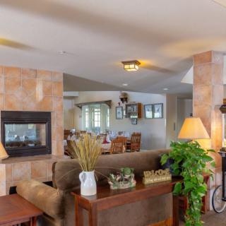 A cozy living room with a fireplace, sofa, and stylish decor.