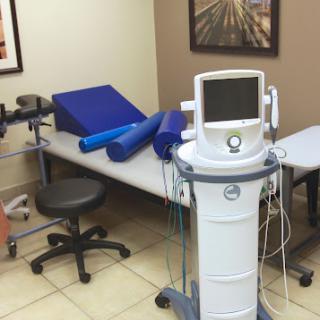 A therapy room equipped with various rehabilitation tools and medical devices.