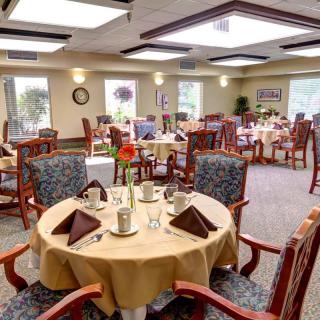 A well-arranged dining area with neatly set tables and comfortable seating.