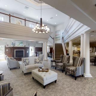 A spacious and elegant lobby with comfortable seating and a modern chandelier.