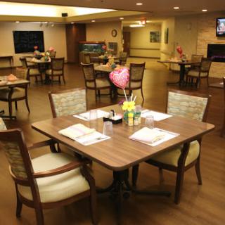 A cozy dining area in a restaurant, featuring well-set tables and comfortable seating.