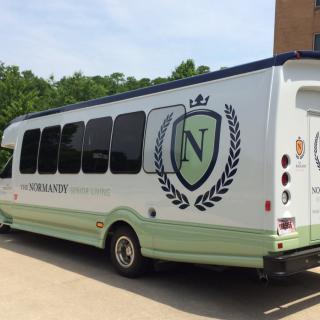 A branded bus parked outdoors on a sunny day.