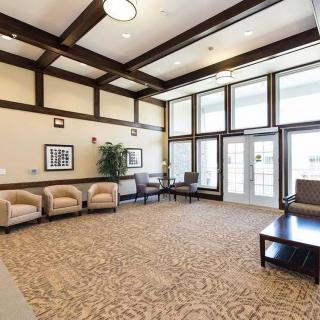 A spacious and well-lit lobby with comfortable seating arrangements.