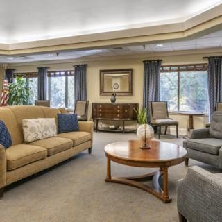A cozy, well-furnished living room with sofas, an armchair, and a coffee table.
