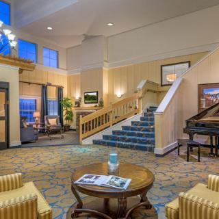 A welcoming hotel lobby with elegant decor and a grand piano.