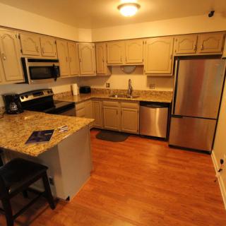 A modern kitchen with granite countertops and stainless steel appliances.