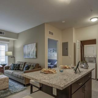 A modern and cozy apartment interior featuring a living room and kitchen area.