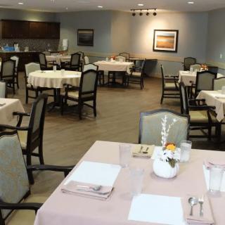 An elegant dining room with neatly arranged tables and chairs, ready for guests.