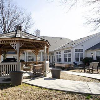 A peaceful backyard patio with a gazebo and outdoor seating area.