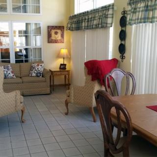 A cozy living and dining area featuring a sofa, dining table with chairs, and tasteful decor.