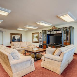 Spacious living room with comfortable sofas and a large television.