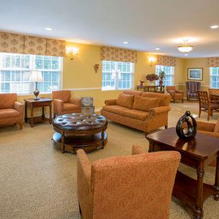 A well-furnished living room with sofas and tables arranged for comfort.