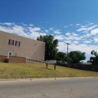 A clear day with a building and blue sky in the background.