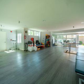 A spacious and minimalist interior room with natural light streaming through large windows.