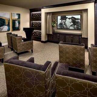 A luxurious home theater with comfortable seating and a large movie screen.