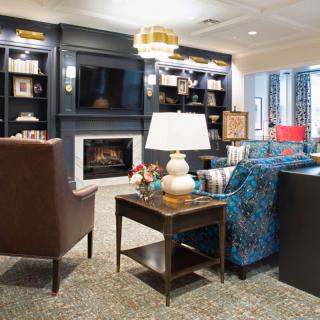 A cozy living room interior featuring a fireplace, comfortable seating, and elegant decor.