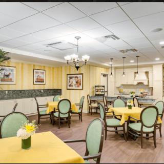 A cozy dining area with yellow tablecloths and elegant decor.