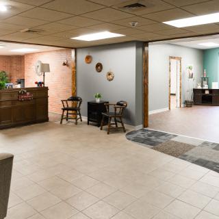 A modern office reception area with a waiting space and decorative elements.