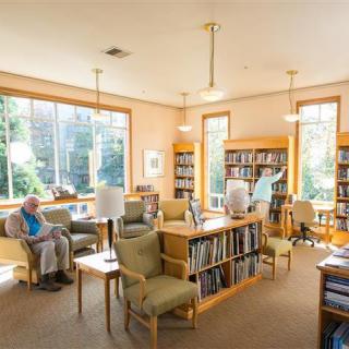 A cozy library reading area with comfortable seating and ample natural light.