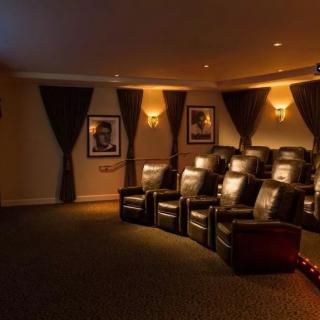 A luxurious home theater with comfortable seating and classic movie posters.