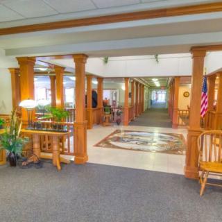 Spacious lobby area with wooden columns and cozy furnishings.