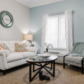 A cozy living room with a sofa, coffee table, and decorative elements.