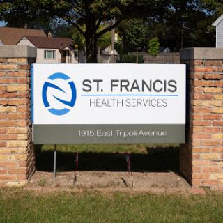 Sign for St. Francis Health Services located in a residential area.