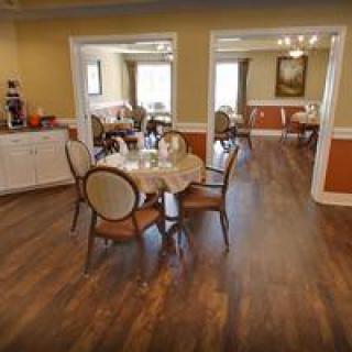 A cozy dining area with elegant furnishings and hardwood flooring.