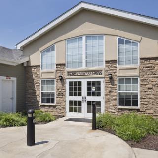 A modern building featuring large windows and a welcoming entrance.