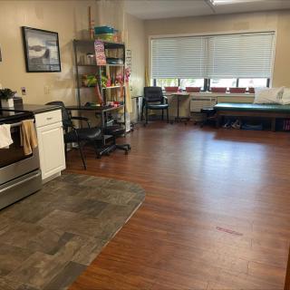 A therapy room equipped with a kitchen and exercise area.