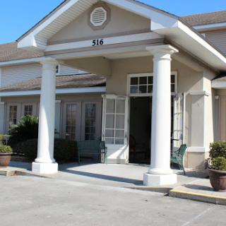 A welcoming entrance featuring classic columns and a spacious porch.