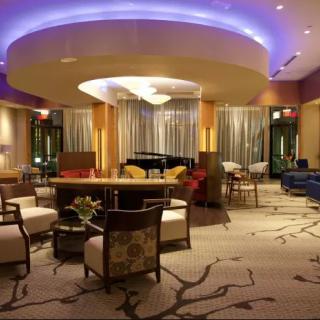 A modern and luxurious hotel lobby with elegant seating and ambient lighting.