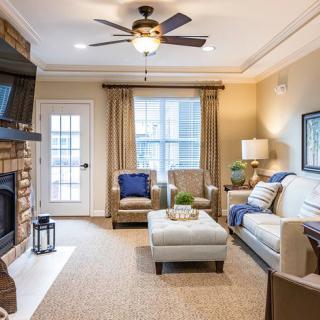 A cozy living room featuring a fireplace, comfortable seating, and elegant decor.