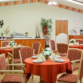 A cozy dining area with elegantly set tables and comfortable seating.