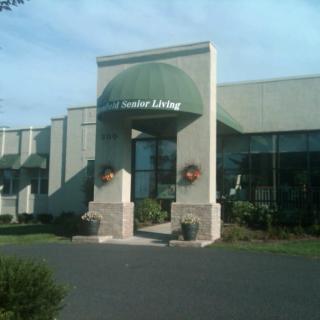 The entrance to an assisted living facility with a green awning.