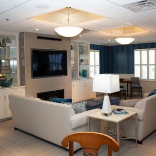A stylish and modern living room featuring a comfortable sofa, a TV, and vibrant blue accents.