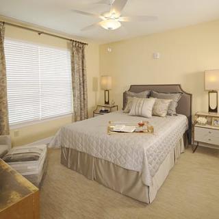 A cozy and well-decorated bedroom with a neatly made bed and stylish decor.