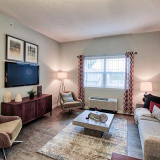 A cozy and modern living room featuring a stylish sofa, coffee table, and contemporary decor.