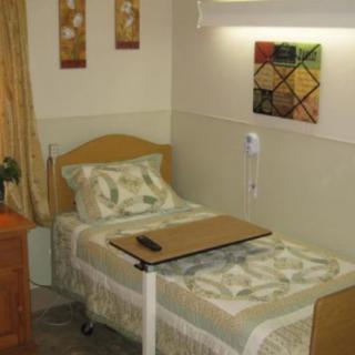 A cozy bedroom with a single bed and decorative wall art.