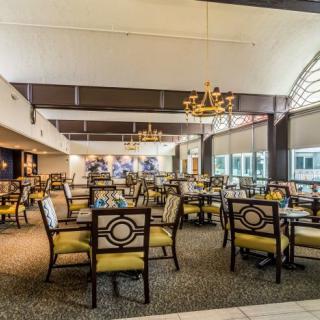 A spacious dining area with elegant furniture and bright lighting.