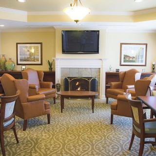 A cozy living room with comfortable seating, a fireplace, and a television.