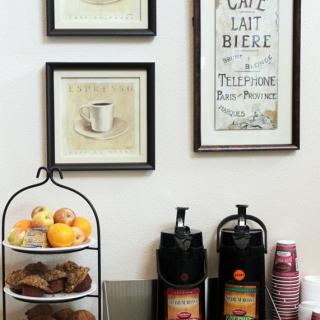 A cozy coffee station with pastries and framed wall art.
