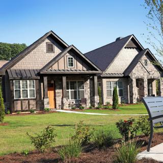 A picturesque residential house with a well-maintained garden and lawn.