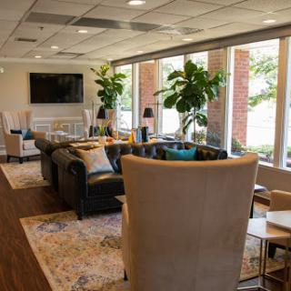 A cozy lounge area featuring modern furniture and plenty of natural light.